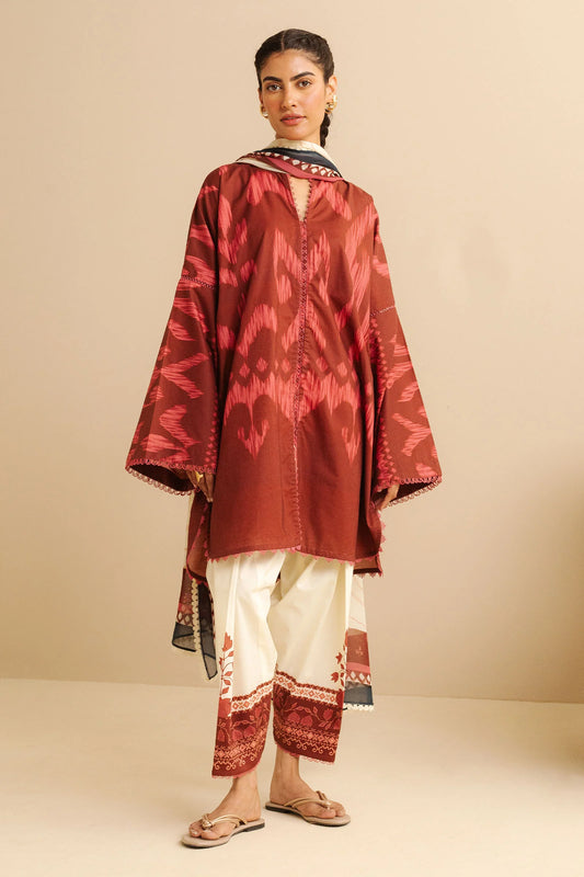 COCO BY ZARA SHAHJAHAN - 3PC UNSTITCHED - A cherry red printed shirt with a dupatta flowing gracefully, paired with white tailored trousers